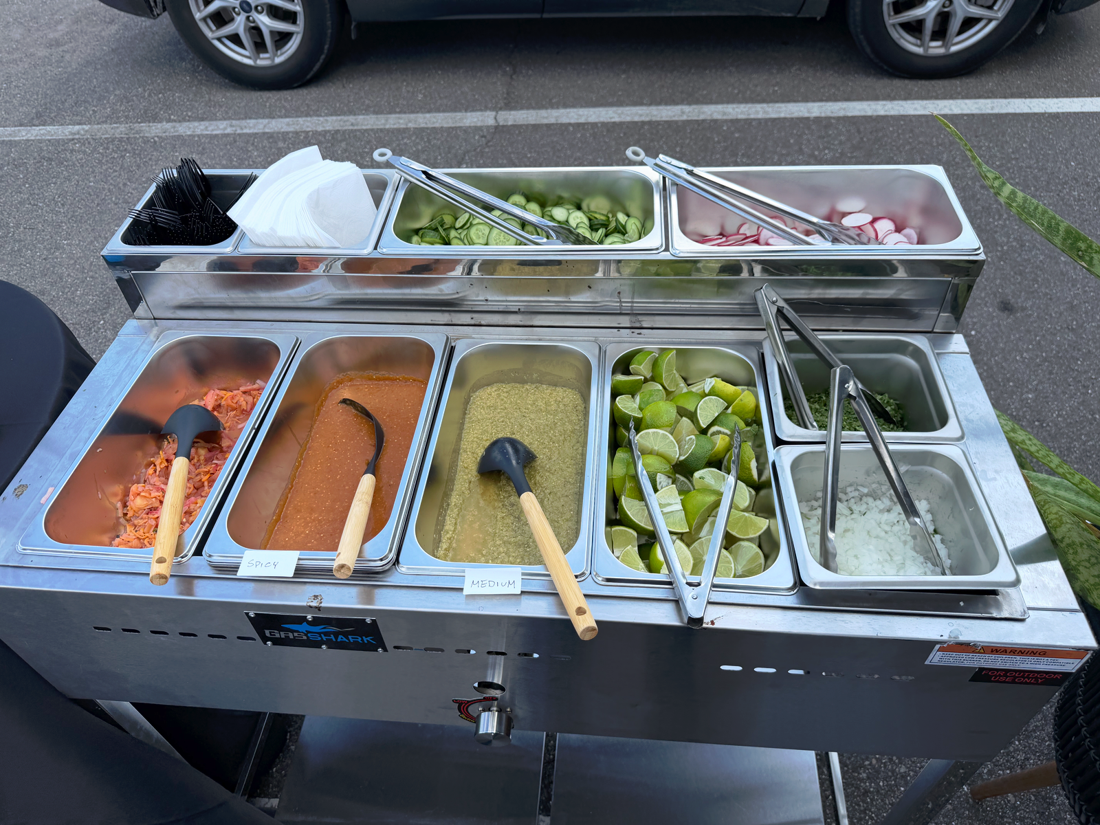 La Ruta toppings and salsa bar set up for catering