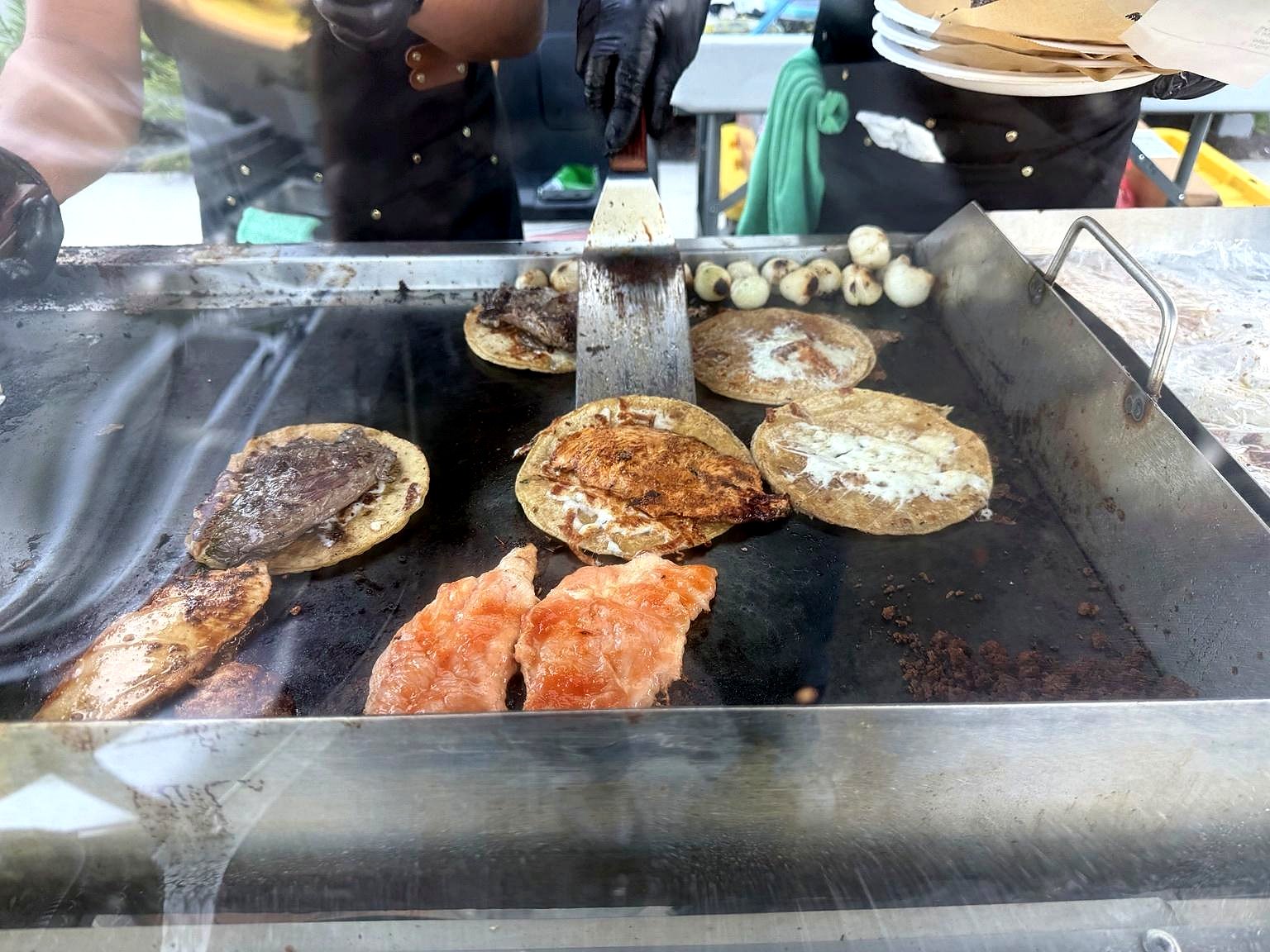 Tacos searing on the flat-top comal
