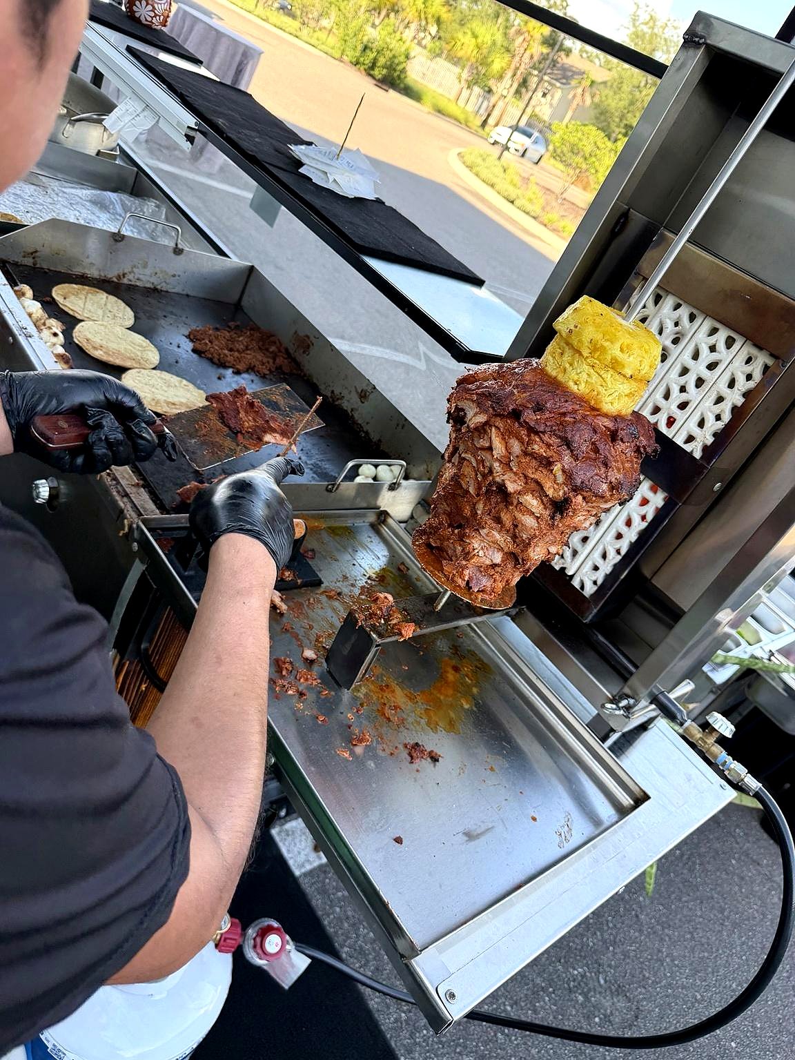 Trompo al pastor carved fresh, layered with pineapple